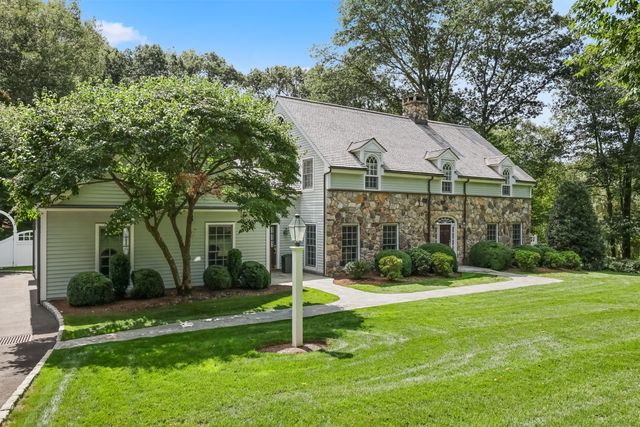 a house that has a big yard and large trees