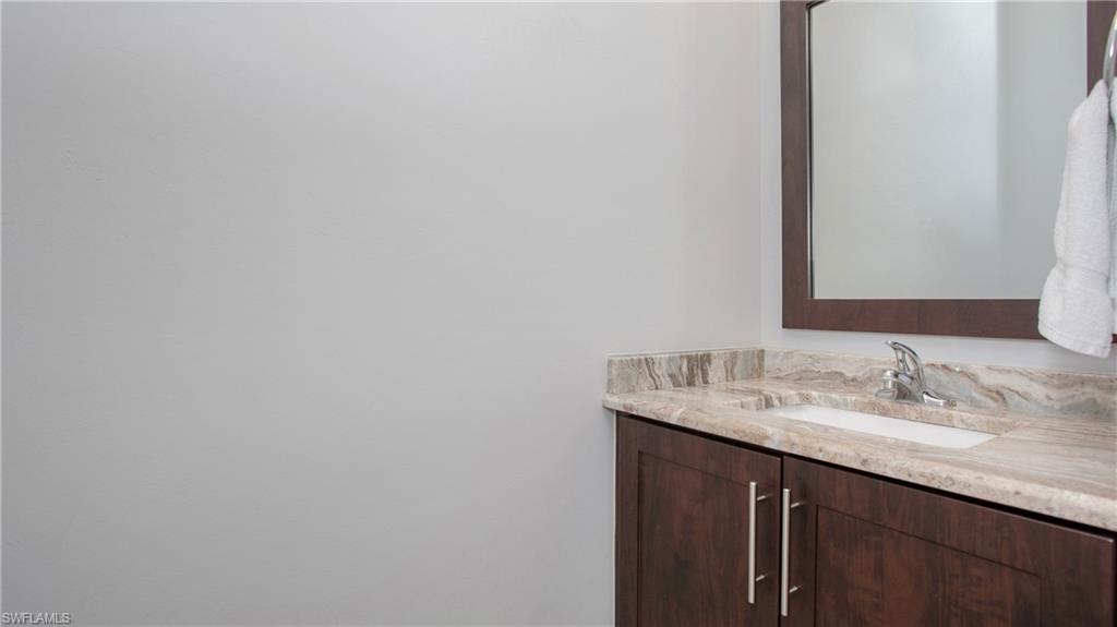 6341 Green Boulevard Naples, FL 34116 - Photo 12 of 48 a bathroom with a sink and a mirror