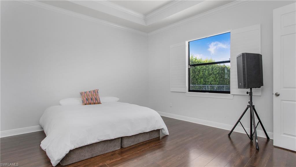 6341 Green Boulevard Naples, FL 34116 - Photo 14 of 48 a bedroom with a bed and a flat screen tv