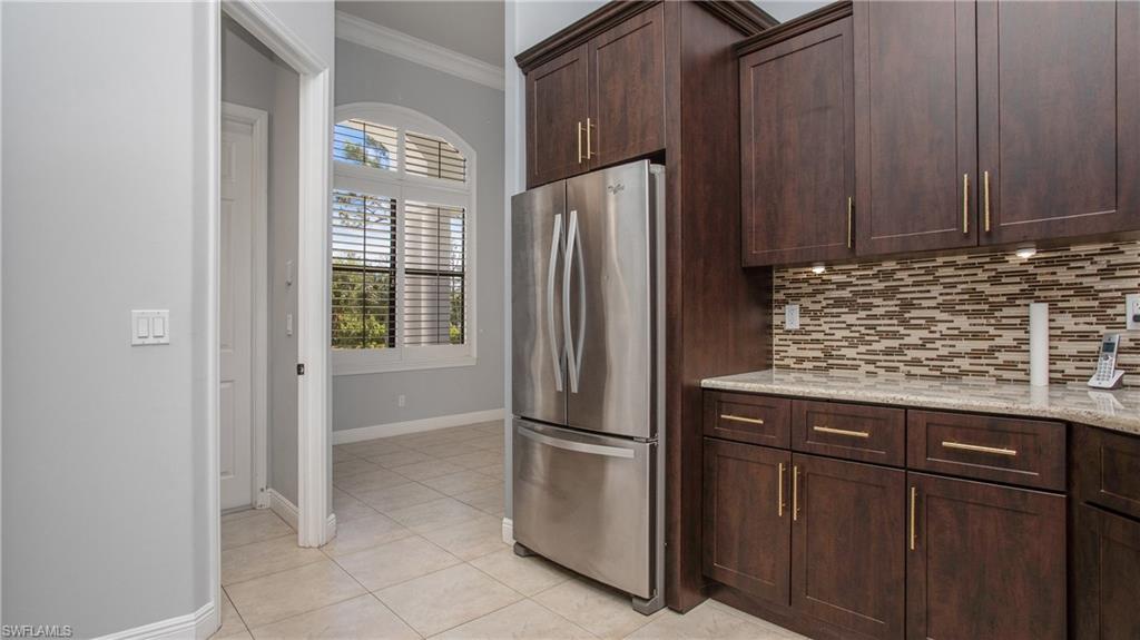 6341 Green Boulevard Naples, FL 34116 - Photo 27 of 48 a kitchen with metallic refrigerator freezer and a dishwasher
