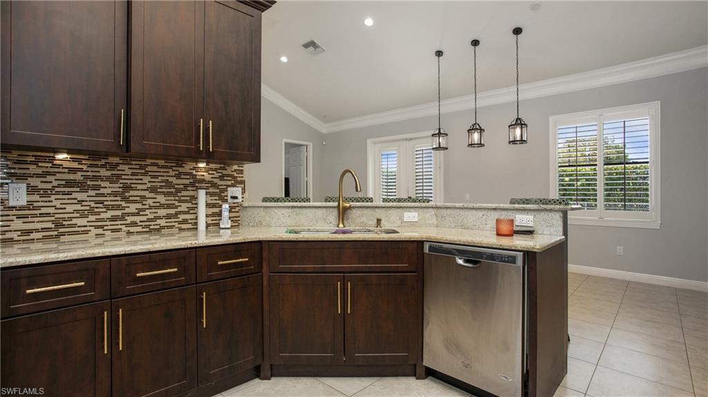6341 Green Boulevard Naples, FL 34116 - Photo 28 of 48 a kitchen with a sink and cabinets