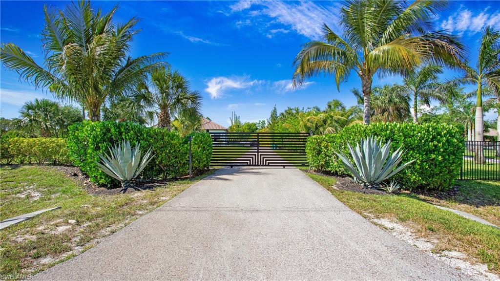 6341 Green Boulevard Naples, FL 34116 - Photo 3 of 48 View of asphalt driveway with a gate and a gated entry