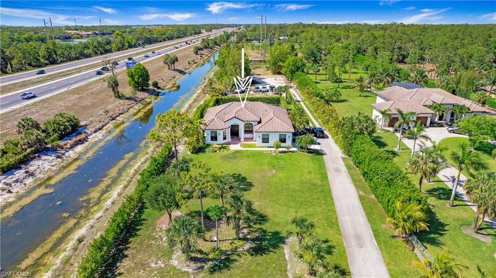 6341 Green Boulevard Naples, FL 34116 - Photo 41 of 48 a view of swimming pool with a yard
