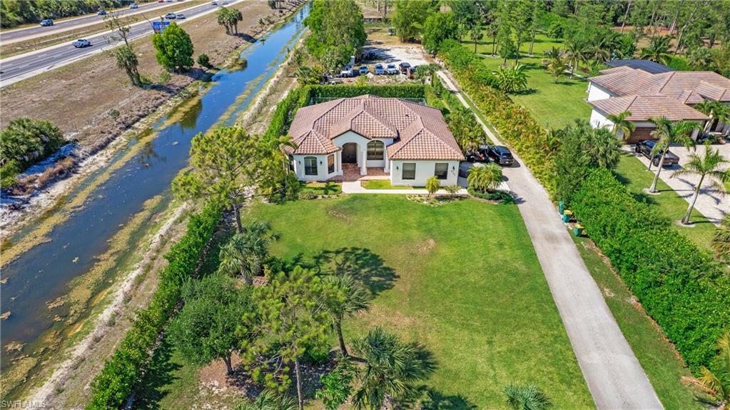 6341 Green Boulevard Naples, FL 34116 - Photo 46 of 48 Aerial view of property and surrounding area with a large body of water