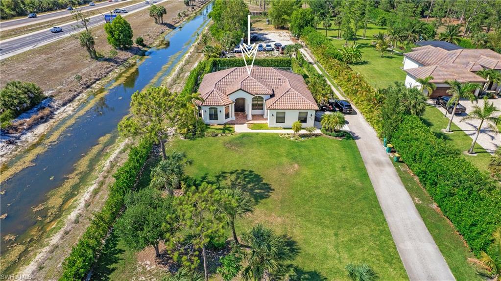 6341 Green Boulevard Naples, FL 34116 - Photo 47 of 48 Aerial view of property and surrounding area featuring a large body of water