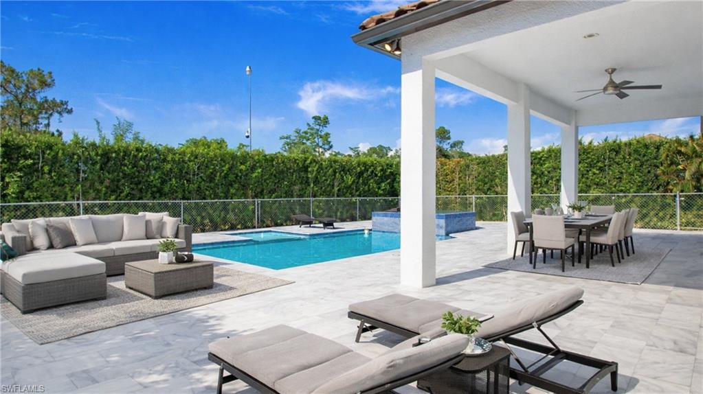 6341 Green Boulevard Naples, FL 34116 - Photo 7 of 48 a view of a patio with a dining table and chairs