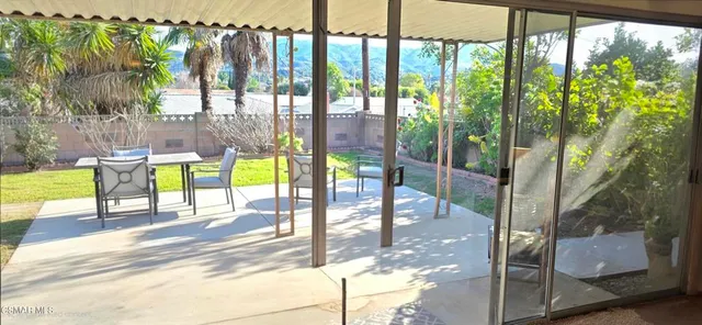 a view of a swimming pool with a patio and a yard