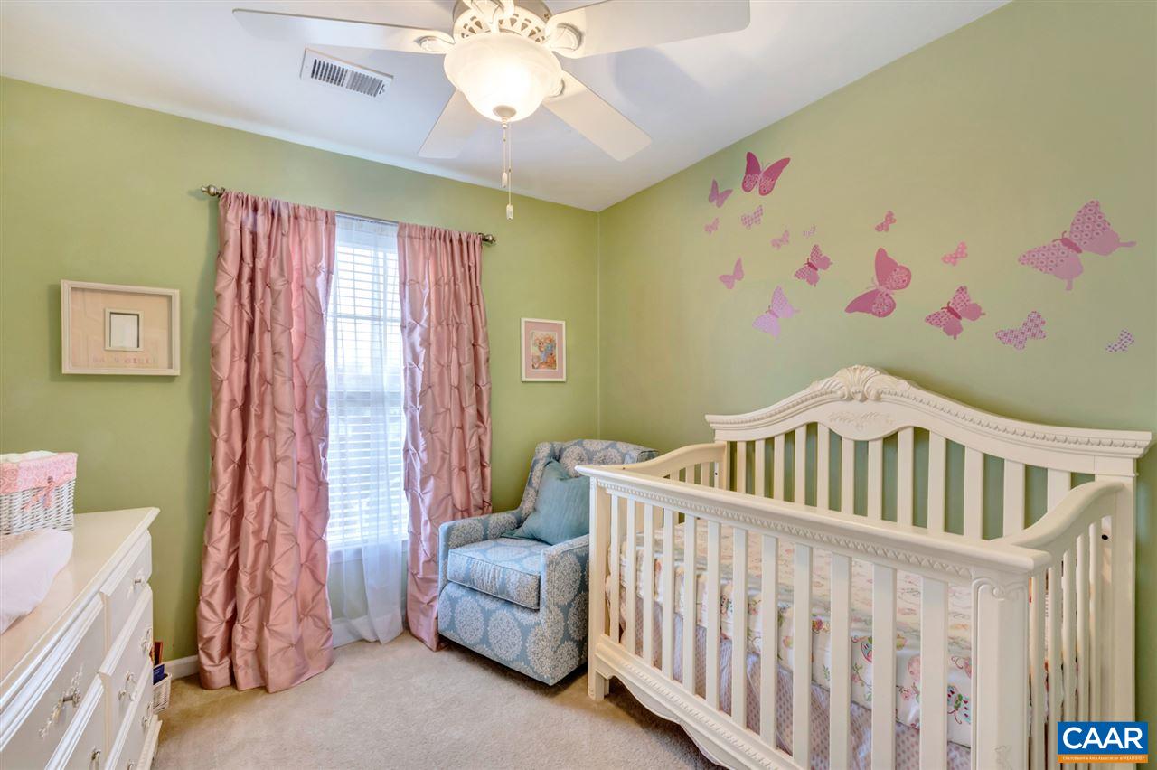 829 Rainier Road Charlottesville, VA 22903 - Photo 11 of 16 a bedroom with a bed and a chandelier
