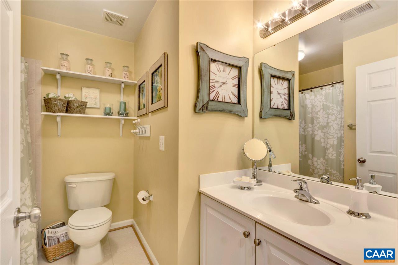 829 Rainier Road Charlottesville, VA 22903 - Photo 13 of 16 a bathroom with a toilet sink a mirror and shower