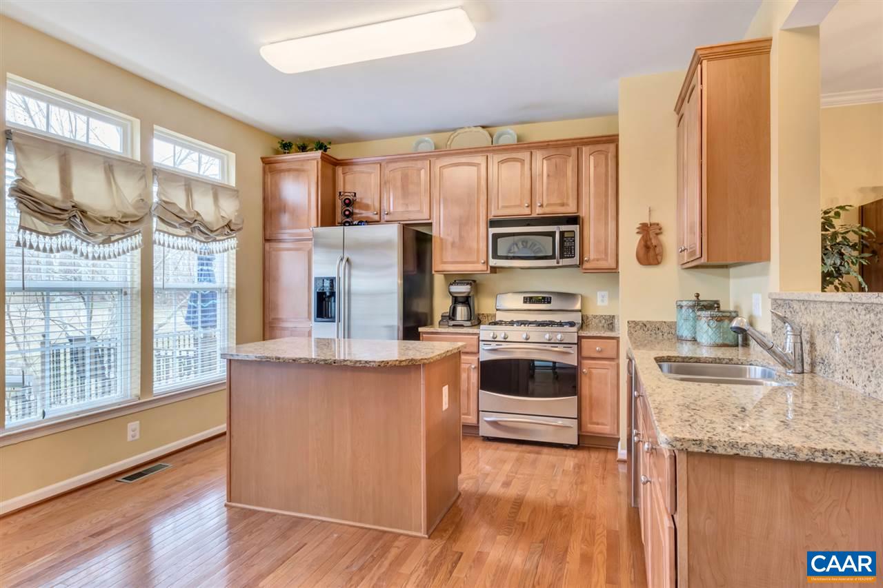 829 Rainier Road Charlottesville, VA 22903 - Photo 3 of 16 a kitchen with stainless steel appliances granite countertop a stove a sink and a refrigerator