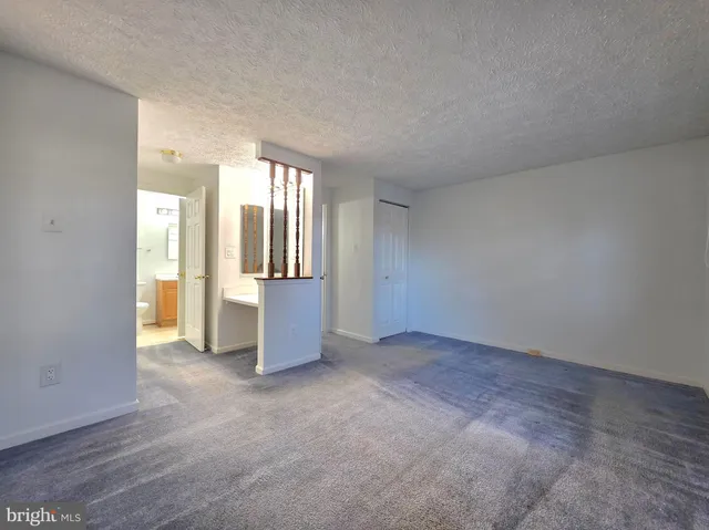 an empty room with windows and closet