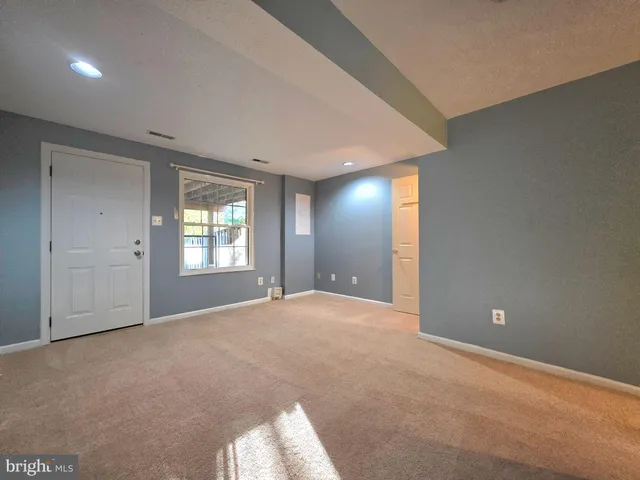 a view of a backyard with wooden fence and trees