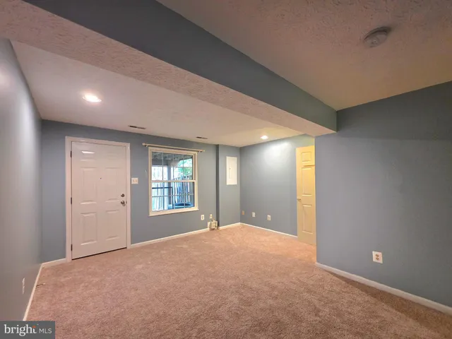 a view of a backyard with wooden fence and trees