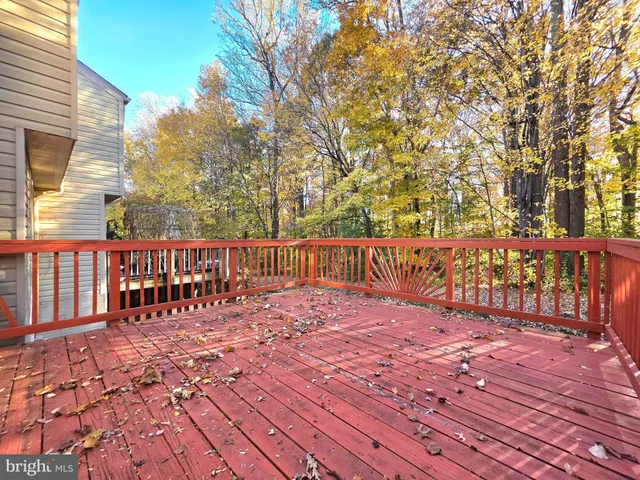 a view of a balcony with floor to ceiling windows wooden floor and fence