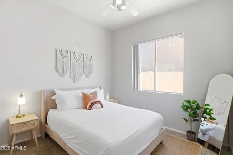 a bedroom with a bed and a potted plant