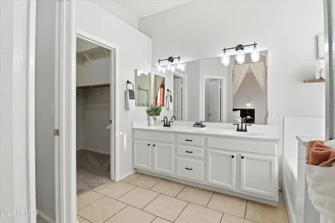 a bathroom with a sink vanity and mirror