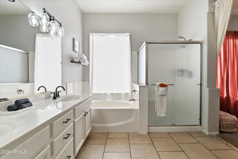a bathroom with a tub sink and mirror