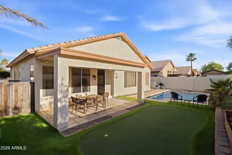 a front view of house with yard and outdoor seating