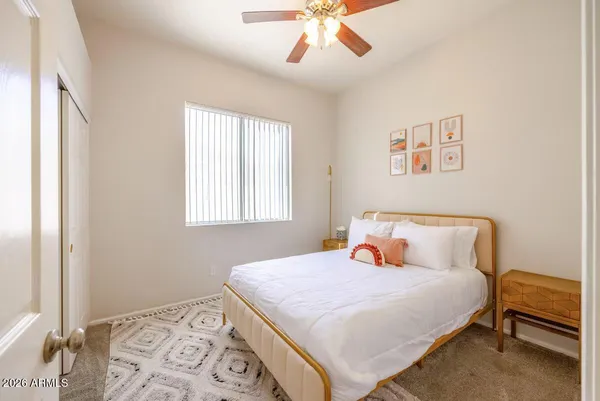 a bedroom with a bed and a window