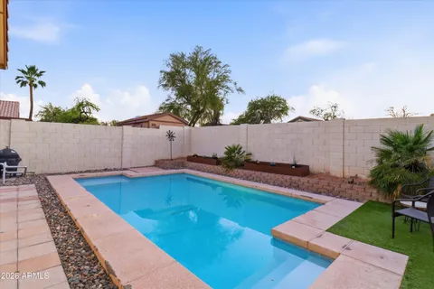 an outdoor space with pool and furniture
