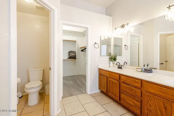 a spacious bathroom with a granite countertop sink toilet and shower