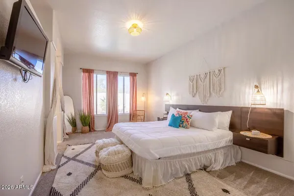 a bedroom with a large bed and a window