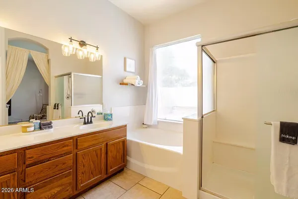 a bathroom with a tub sink and mirror