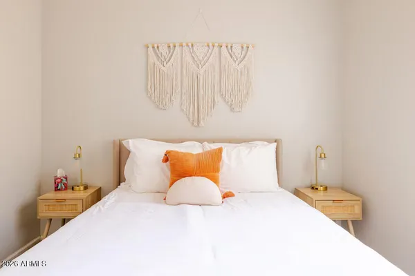 a bedroom with a bed and a night stand