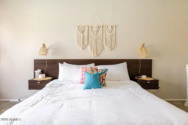 a bed room with a bed and a night stand