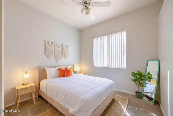 a bedroom with a bed and a potted plant