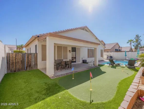 a view of a house with backyard porch and sitting area