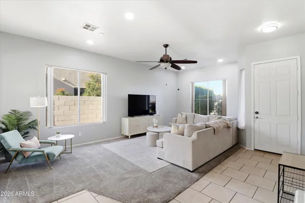 a living room with furniture and floor to ceiling window