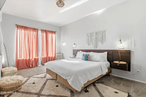 a bedroom with a bed and a couch