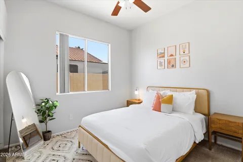 a bedroom with a bed and a potted plant