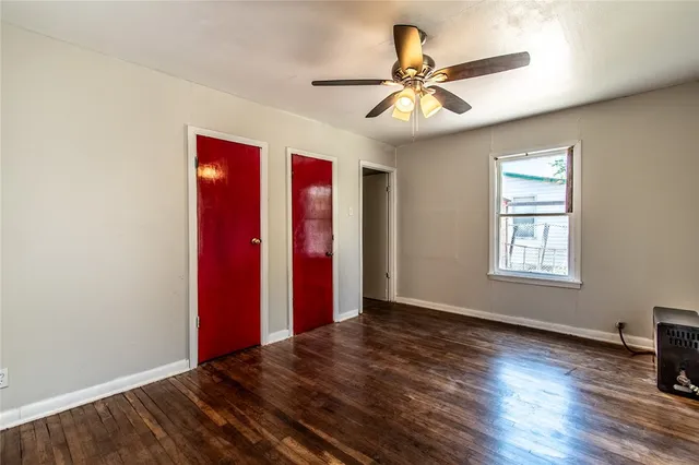 a view of a room with wooden floor and window