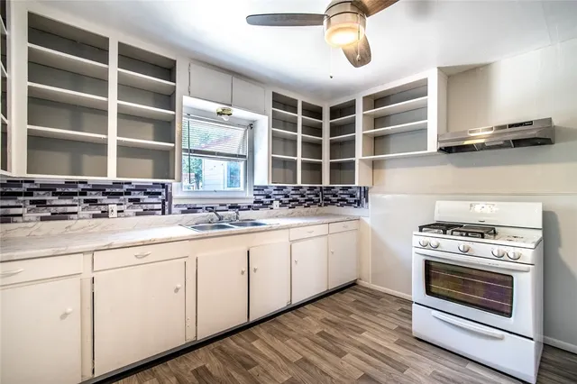 a kitchen with stainless steel appliances a stove and cabinets
