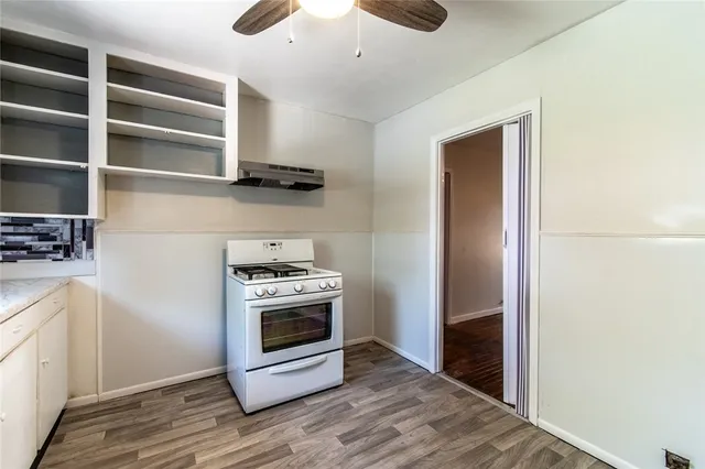 a kitchen with a stove and a refrigerator