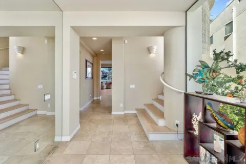 a view of an entryway with wooden floor and a potted plant
