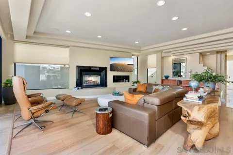 a living room with fireplace furniture and a flat screen tv