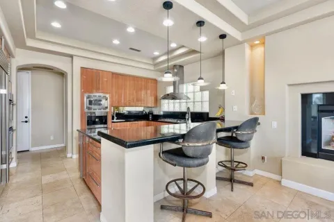 a kitchen with stainless steel appliances kitchen island granite countertop a sink and cabinets
