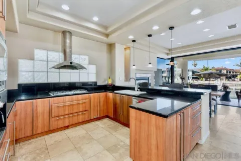 a kitchen with stainless steel appliances granite countertop a sink counter space and a stove