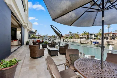 a view of a patio with dining table and chairs under an umbrella