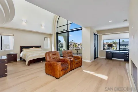 a bedroom with furniture and a large window