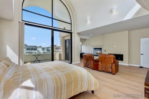 a large bedroom with a large bed and a large window
