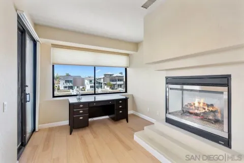 a room with painting and a fireplace