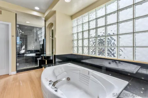 a bathroom with a tub sink and mirror