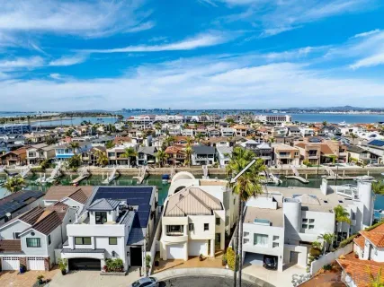 an aerial view of residential houses with city view