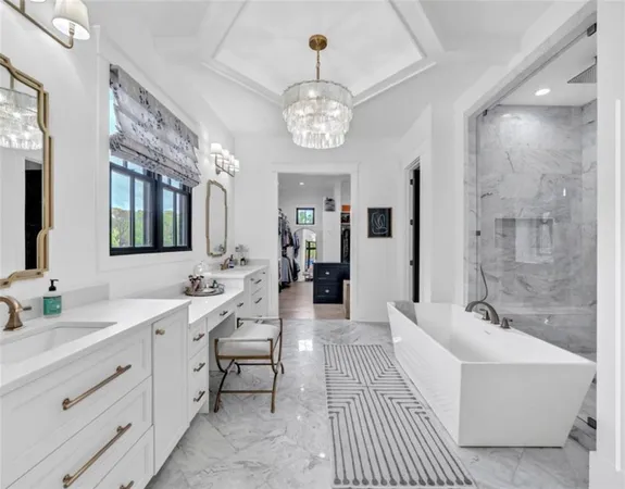 a living room with furniture a fireplace and a chandelier