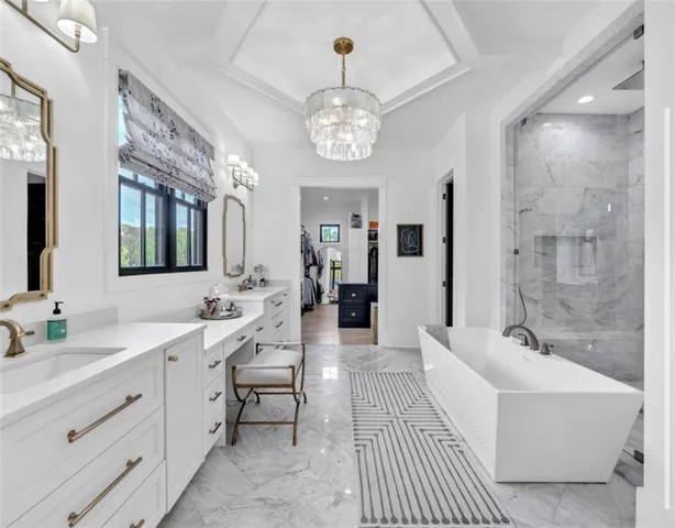 a living room with furniture a fireplace and a chandelier