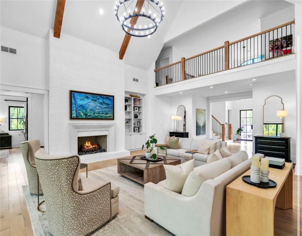 1560 Howell Bridge Road Ball Ground, GA 30107 - Photo 8 of 14 a living room with furniture a fireplace and a chandelier